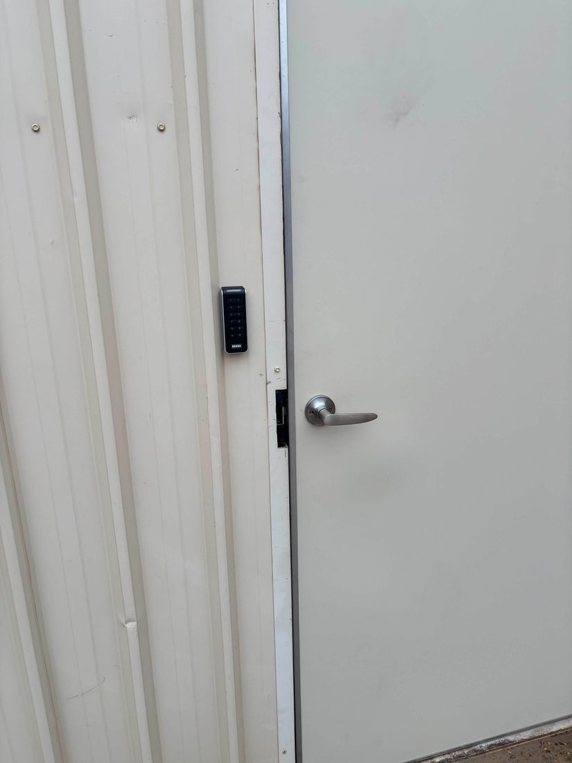 HID Signo smart access control reader installed beside a commercial door